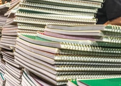 large stacks of notebooks on a table