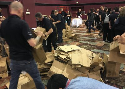 lots of team members breaking down empty boxes