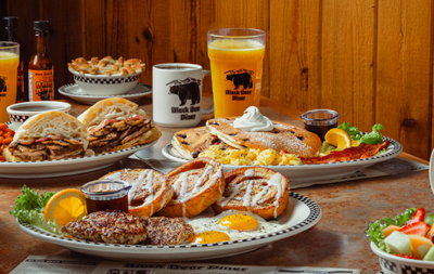 Breakfast and lunch entrees with OJ and coffee.