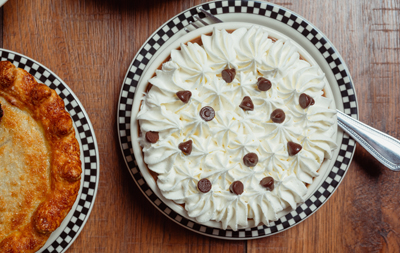 Pie with whipped cream and chocolate chips.