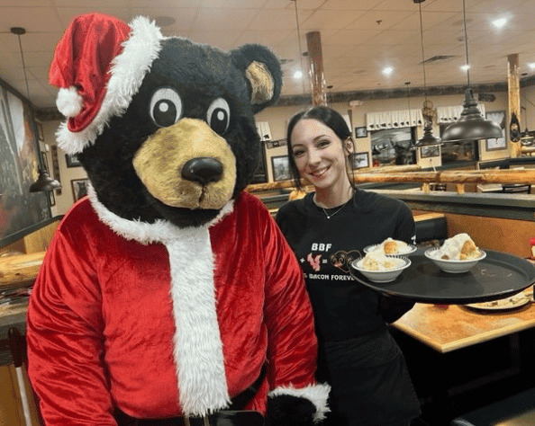 Black Bear Mascot and Server pose for a Photo